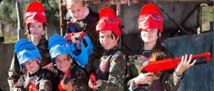 kids playing paintball with red and blue gotcha markers
