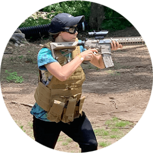 photo of a woman holding an airsoft gun